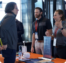 Event registration desk with attendees checking in at expo entrance